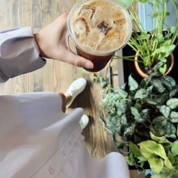 a person holding iced coffee