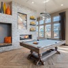 a clubhouse room with a pool table and a large window